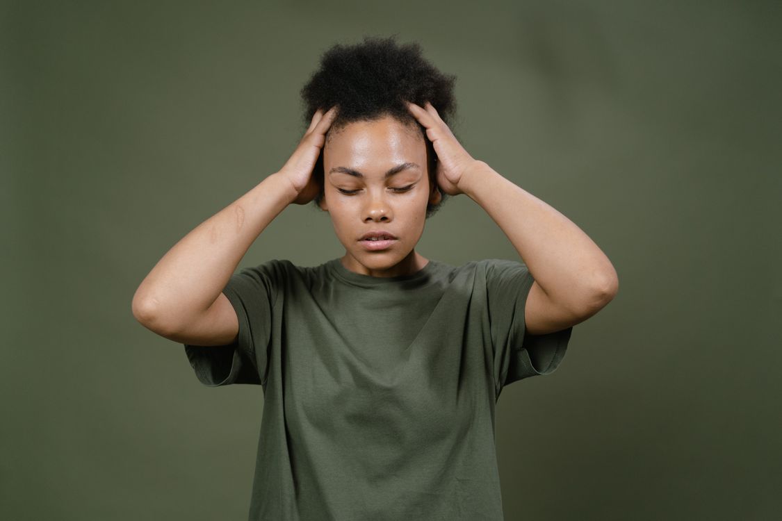Woman holding her head, showing headache discomfort