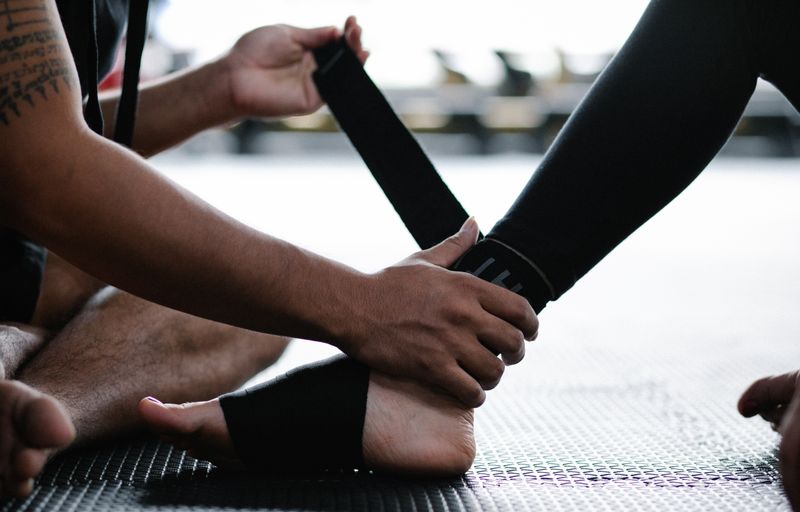 Athlete's ankle being wrapped with an elastic bandage